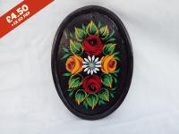 Oval Pottery Wall Plaque, black background,  hand-painted with traditional canal rose design.
